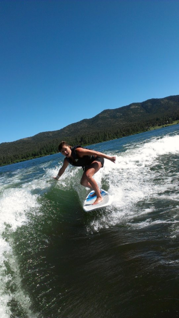 girl wake surfing wave